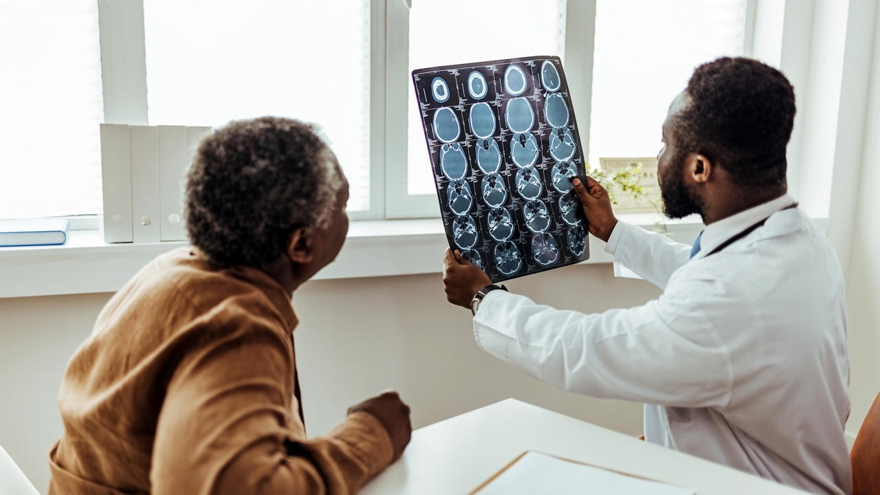 Male Doctor and Patient Examining brain MRI