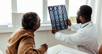 Male Doctor and Patient Examining brain MRI